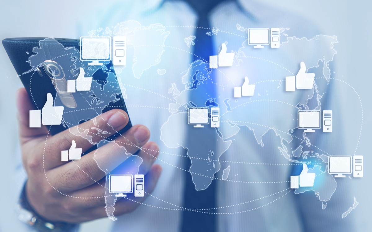 freepik-like-network-and-technology-man-holding-smartphone-background