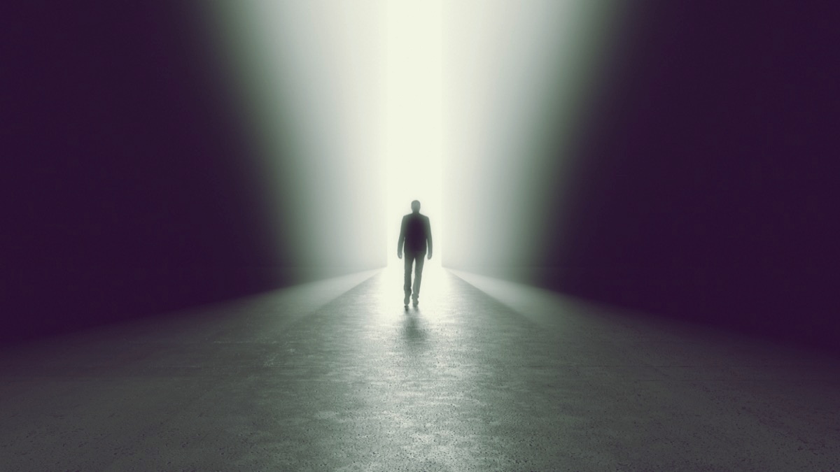 freepik-man-getting-out-from-the-darkness
